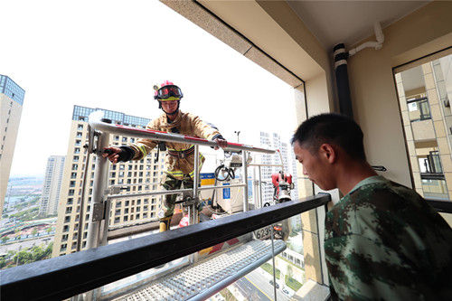 云梯车到达61米高的18楼营救被困人员。颜杰
